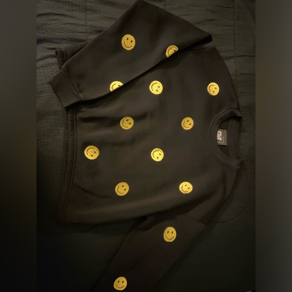 Large black sweater with yellow smiley faces